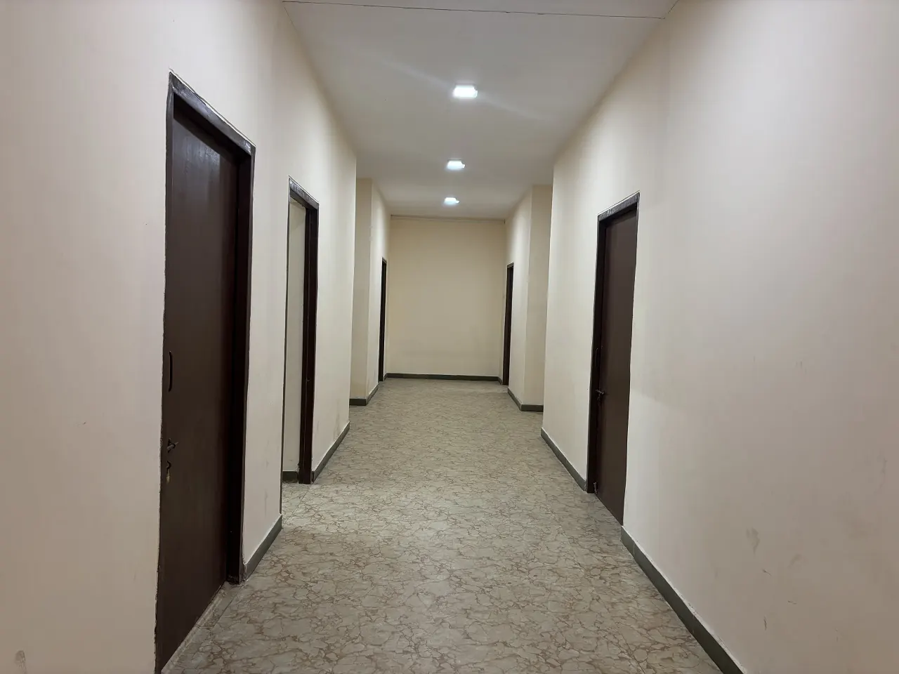 Clean corridor to the rooms at Guru Kripa Hotel, Agolai